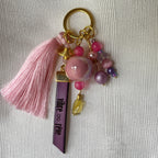 Bijou de sac doré multi breloques en perles Rose et message cuir gravé