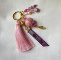 Bijou de sac doré multi breloques en perles Rose et message cuir gravé